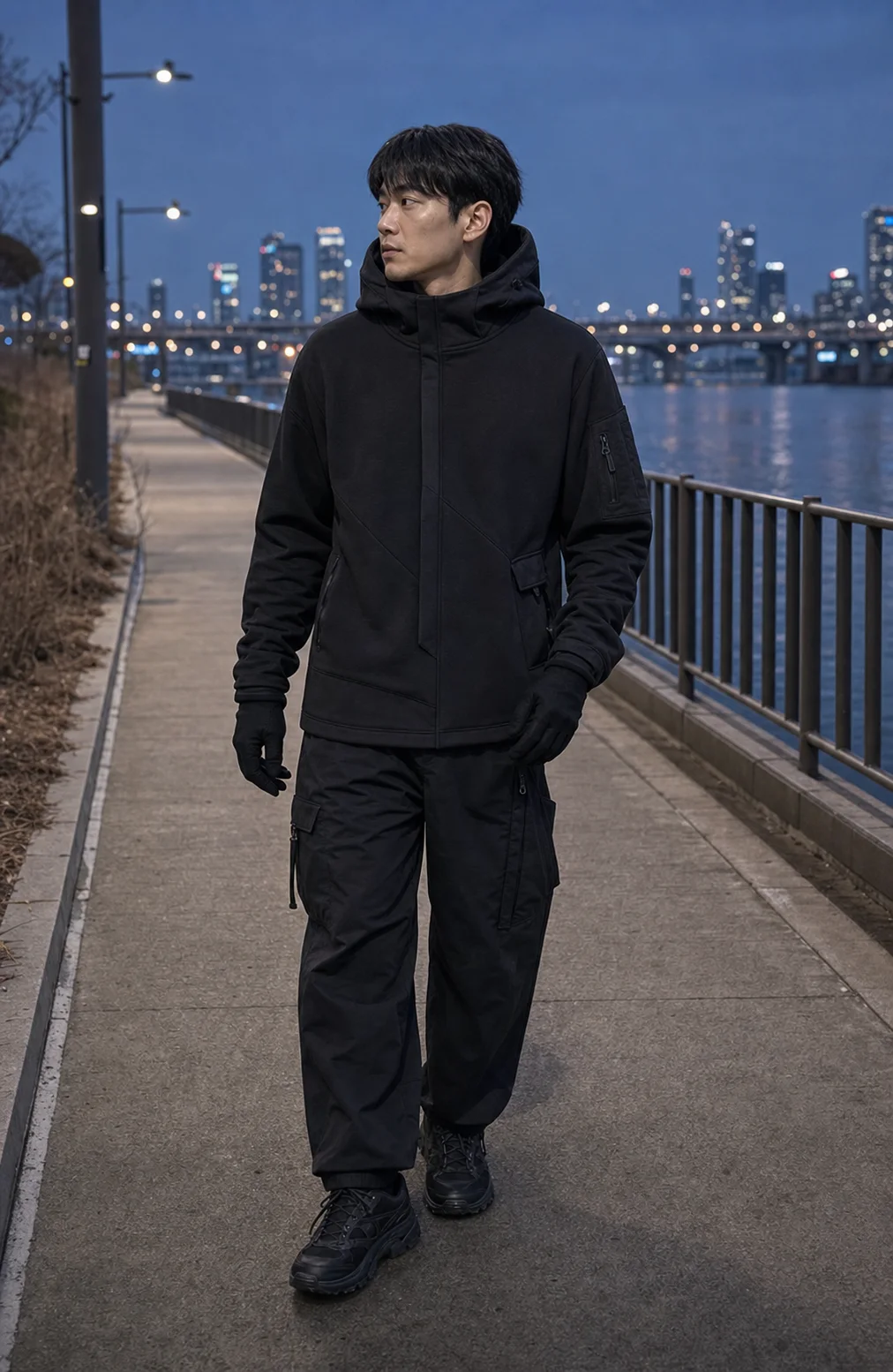 Seoul riverside styling image showing the Clothixpack CXP-H106 Veer Technical Hoodie with charcoal cargo trousers and trail sneakers.