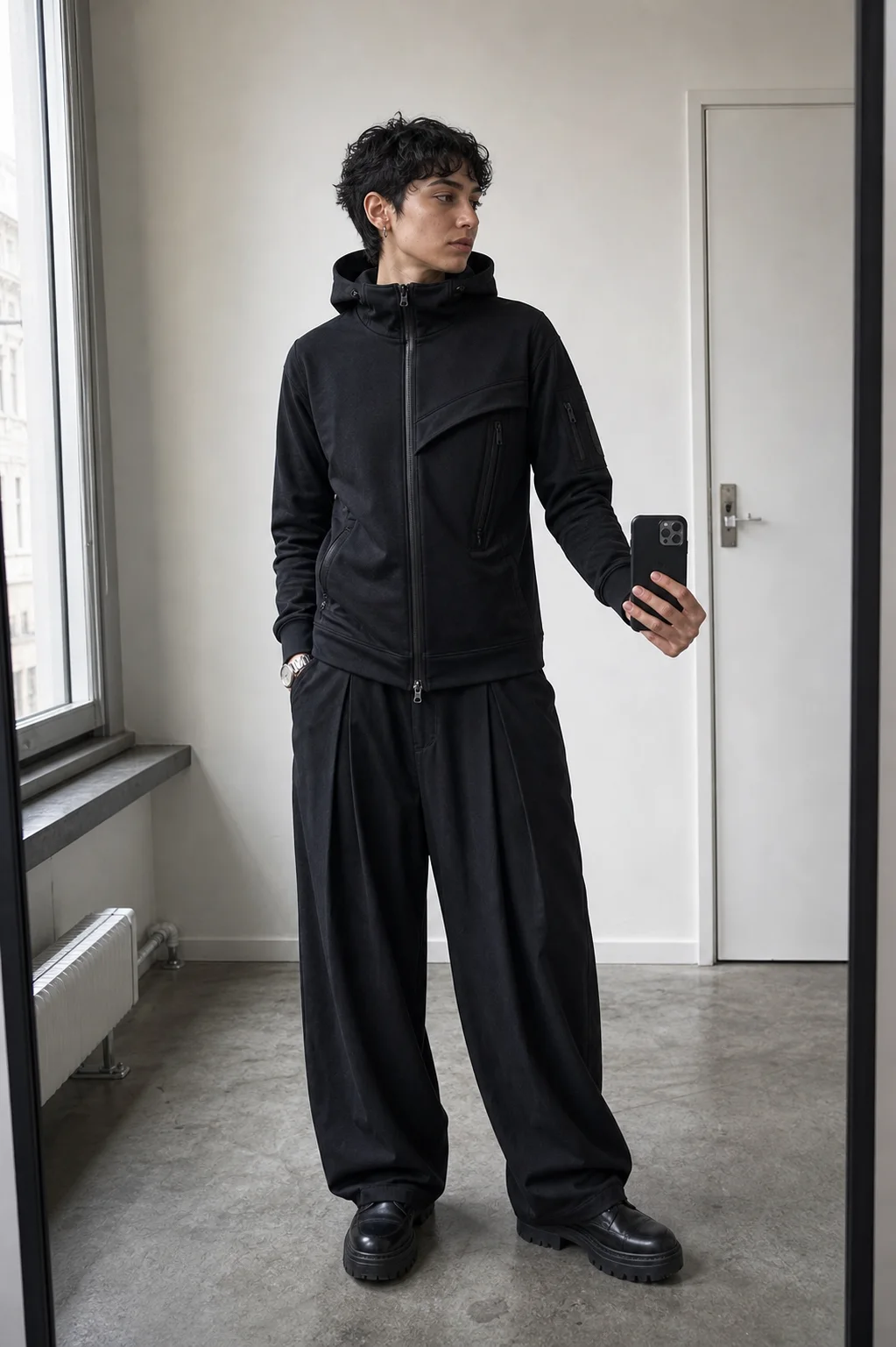 Berlin apartment mirror styling image showing the Clothixpack CXP-H108 Fold Zip Hoodie with black pleated wide-leg trousers.