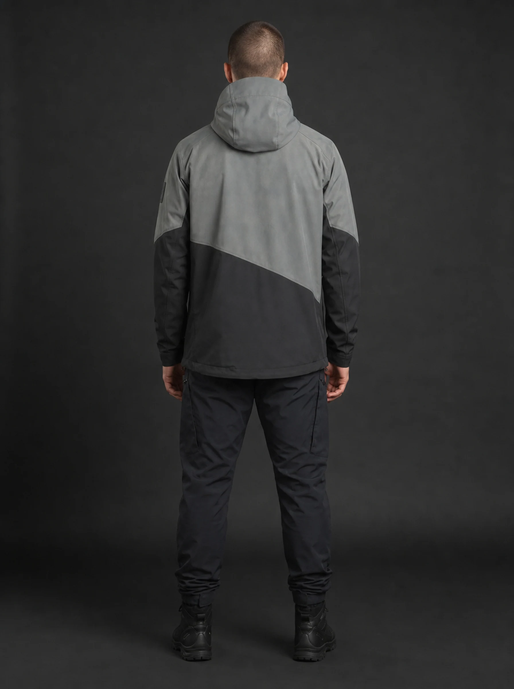 Grid Hardshell Jacket rear view showing the grey and black diagonal back panels