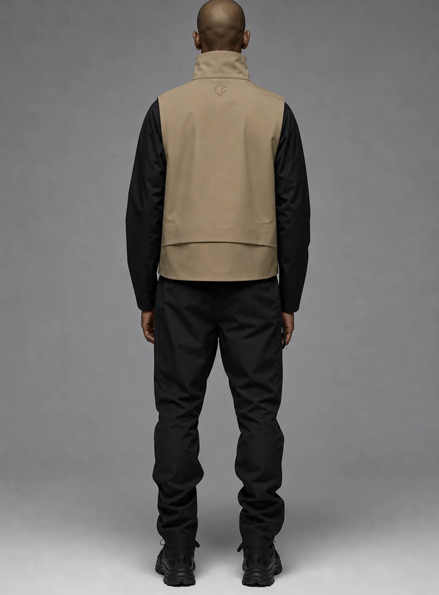 Sand Arc Vest back view showing matching Clothixpack construction and naturally integrated branding