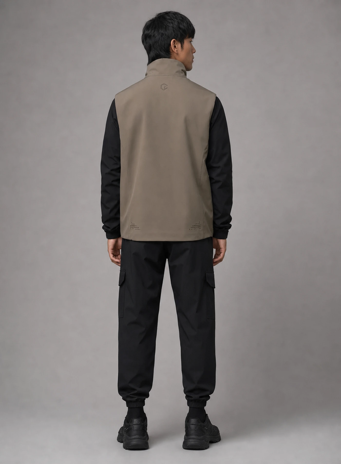 Taupe Cocoon Vest back view showing matching Clothixpack construction and naturally integrated branding